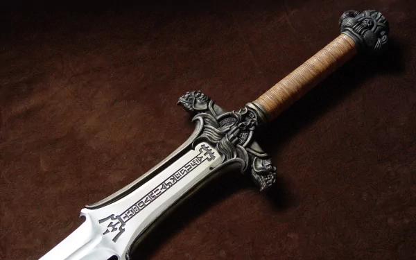A detailed close-up of an ornate, man-made sword with intricate designs on the blade and a textured handle, set against a rich, dark background, forming an impressive HD desktop wallpaper.