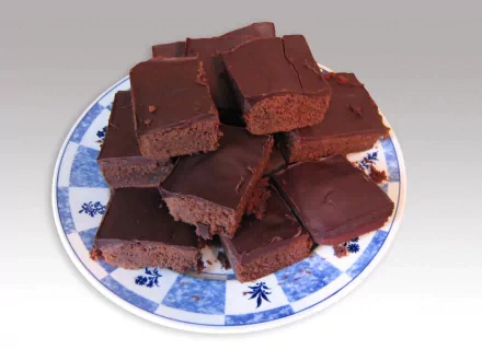 A tempting display of brownies on a decorative plate, showcasing rich chocolate treats. This HD wallpaper celebrates the indulgence of sweets and delicious desserts.