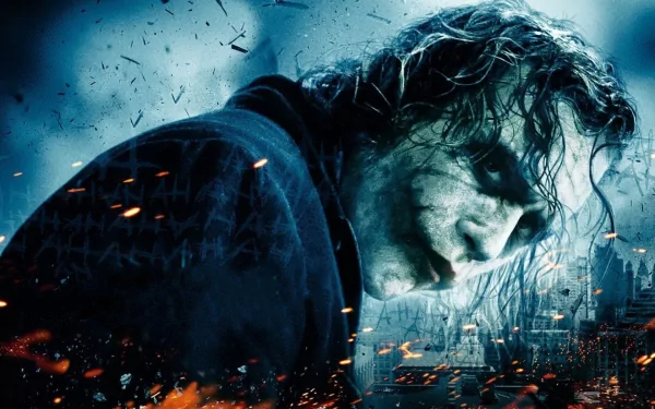 HD desktop wallpaper featuring the Joker from the movie The Dark Knight, with a dark and eerie background infused with fiery elements and scattered debris.