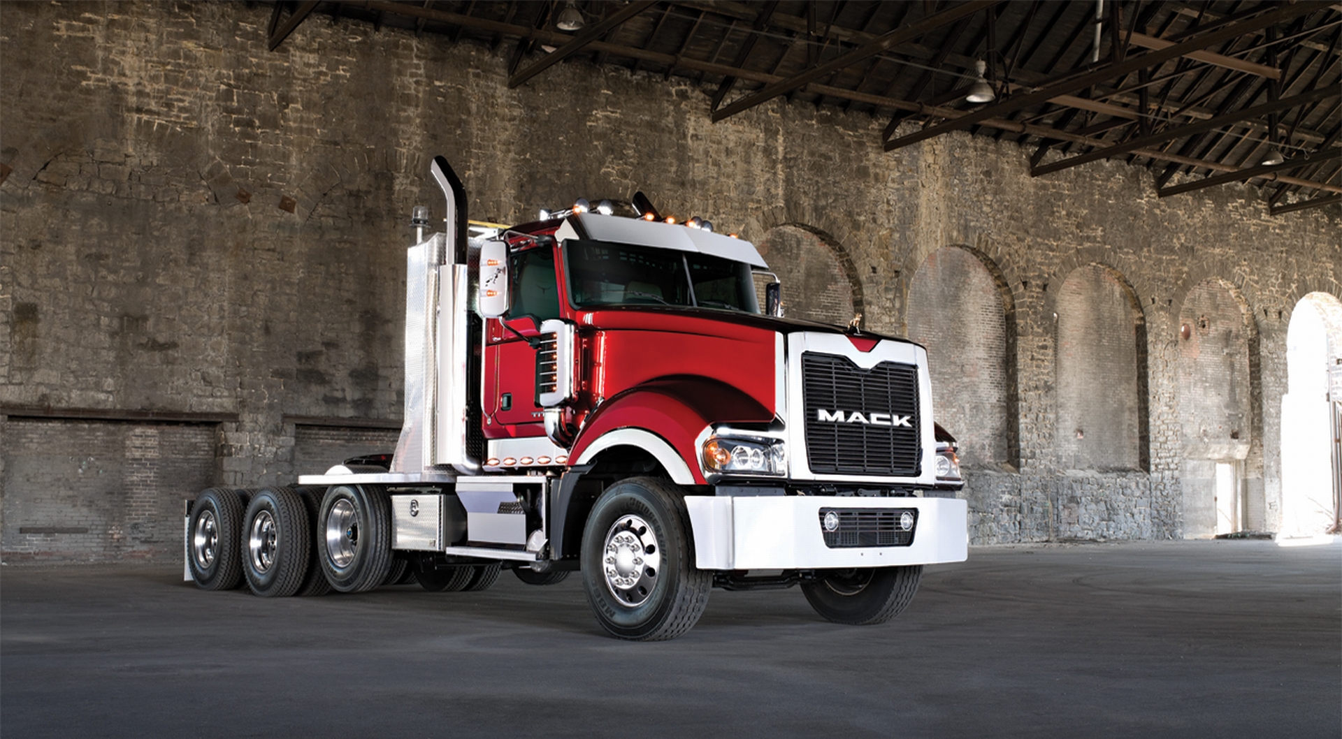 A parked Mack truck with a striking design, ready to hit the road.