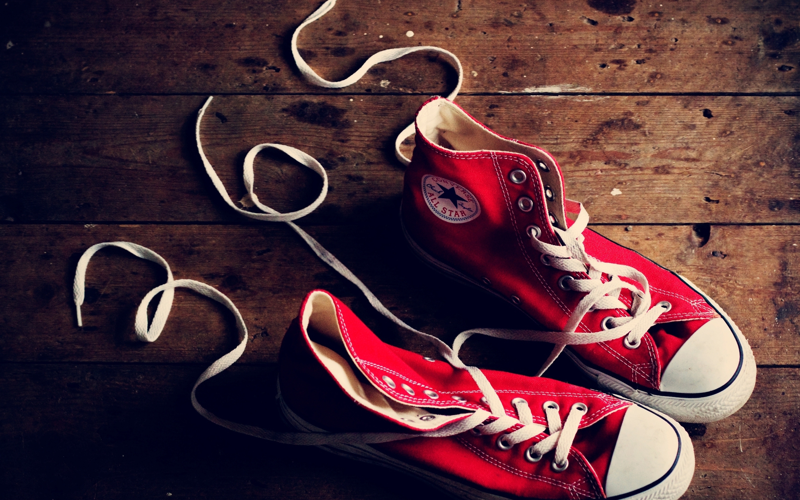 A vibrant and stylish desktop wallpaper featuring classic Converse footwear.