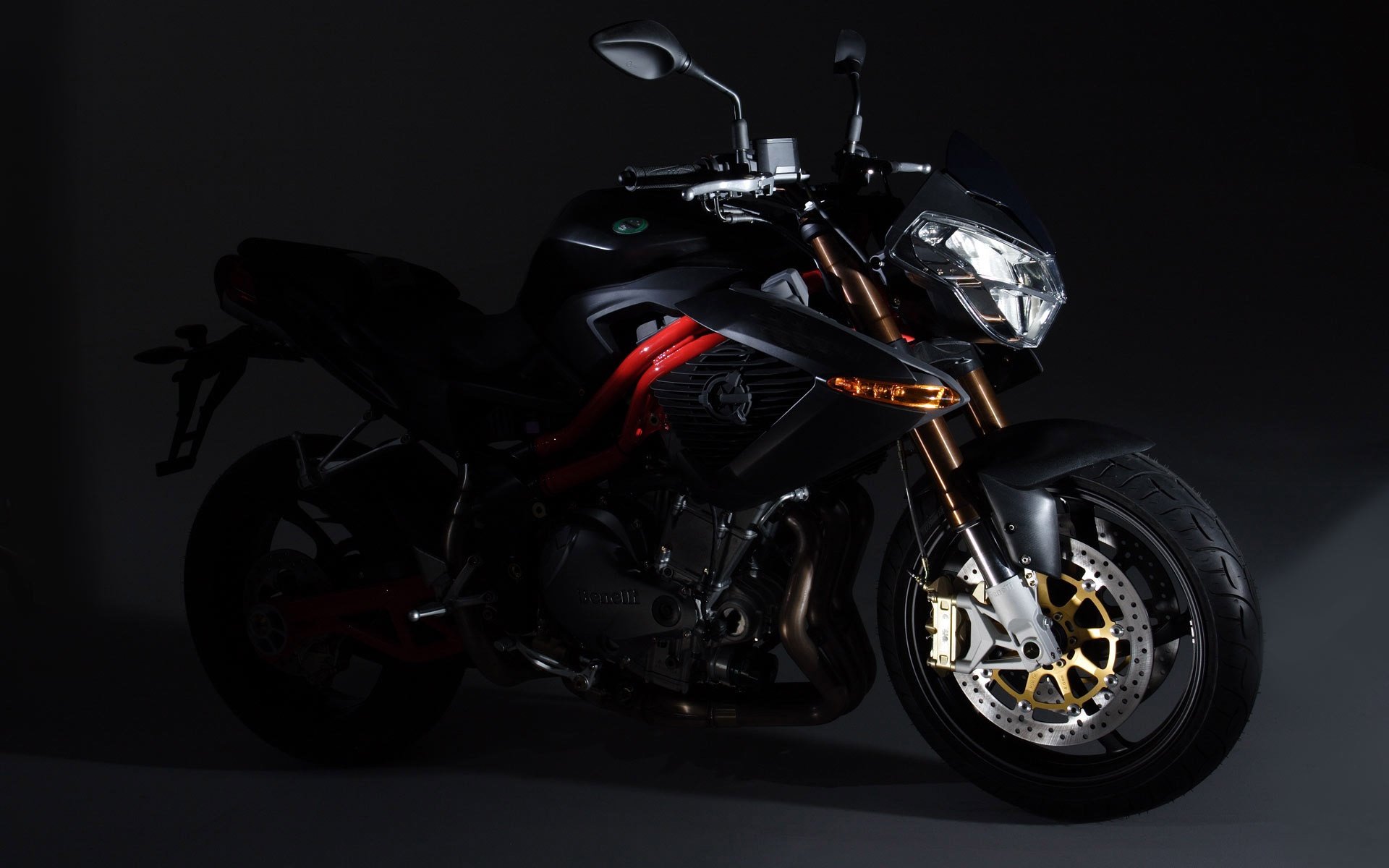 A sleek black Harley-Davidson motorcycle showcased against a dark background, captured in a high-definition desktop wallpaper style.