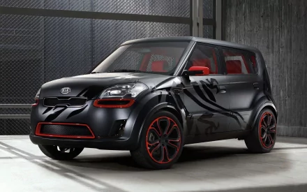 HD PC desktop wallpaper and background: black Kia Soul vehicle with red accents, custom side graphics and red interior, parked in an industrial garage setting.