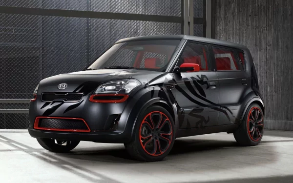 HD PC desktop wallpaper and background: black Kia Soul vehicle with red accents, custom side graphics and red interior, parked in an industrial garage setting.