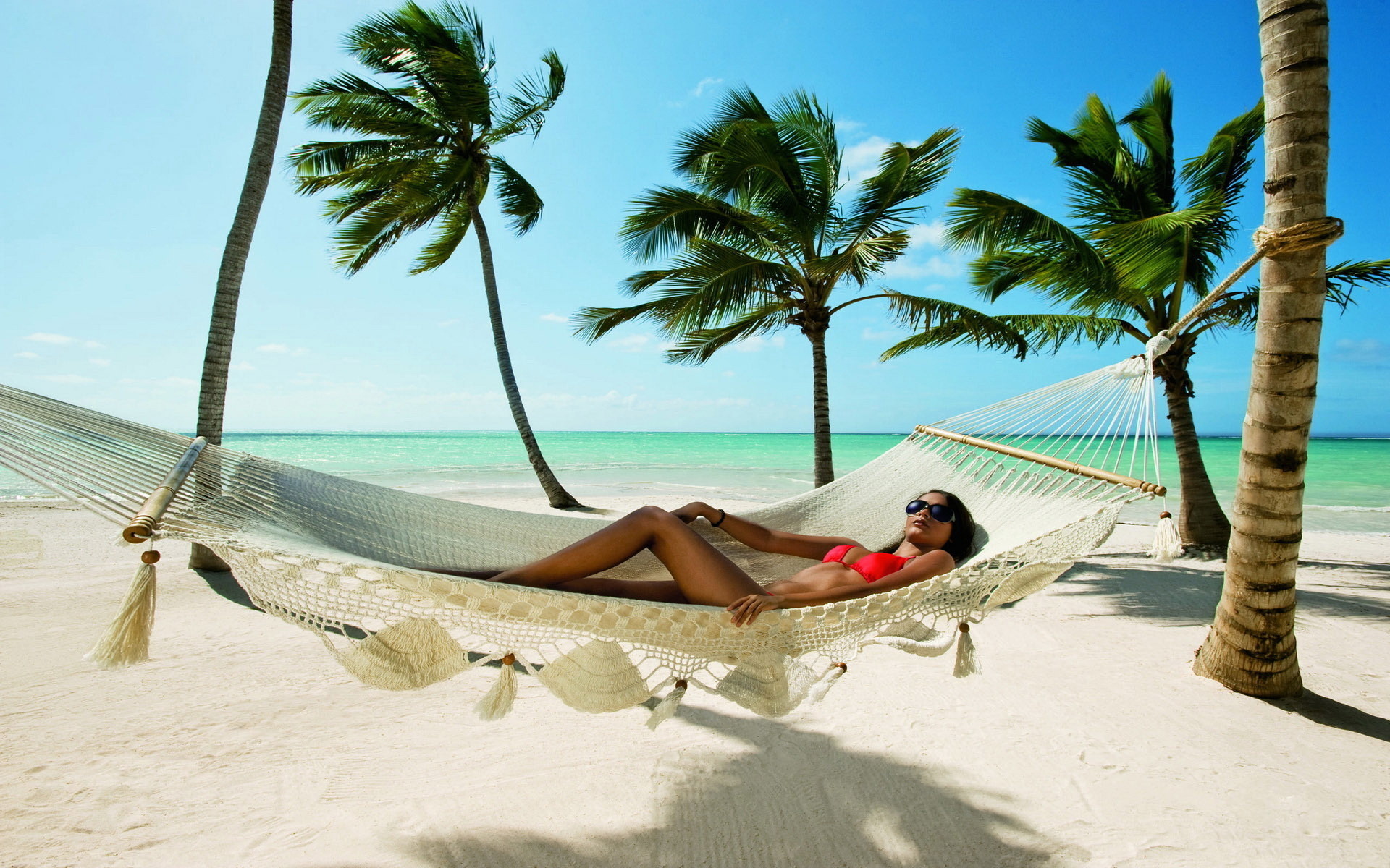 Tropical paradise featuring women in bikinis.