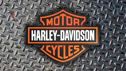 Harley-Davidson logo in bold orange and white on a textured metallic background, designed as an HD PC desktop wallpaper and background featuring the iconic vehicle brand.