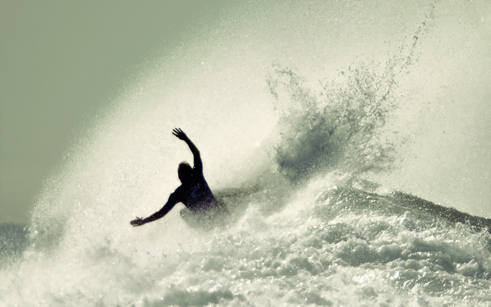 Surfer conquering massive waves, combining athleticism and nature's power.