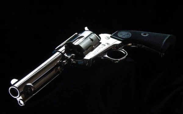 HD PC desktop wallpaper featuring a detailed, polished Colt revolver against a black background, highlighting the craftsmanship of this man-made firearm.