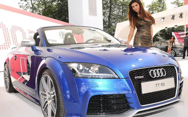HD PC desktop wallpaper featuring a woman posing beside a sleek blue Audi TT RS convertible, blending themes of girls and cars in a vibrant outdoor setting.