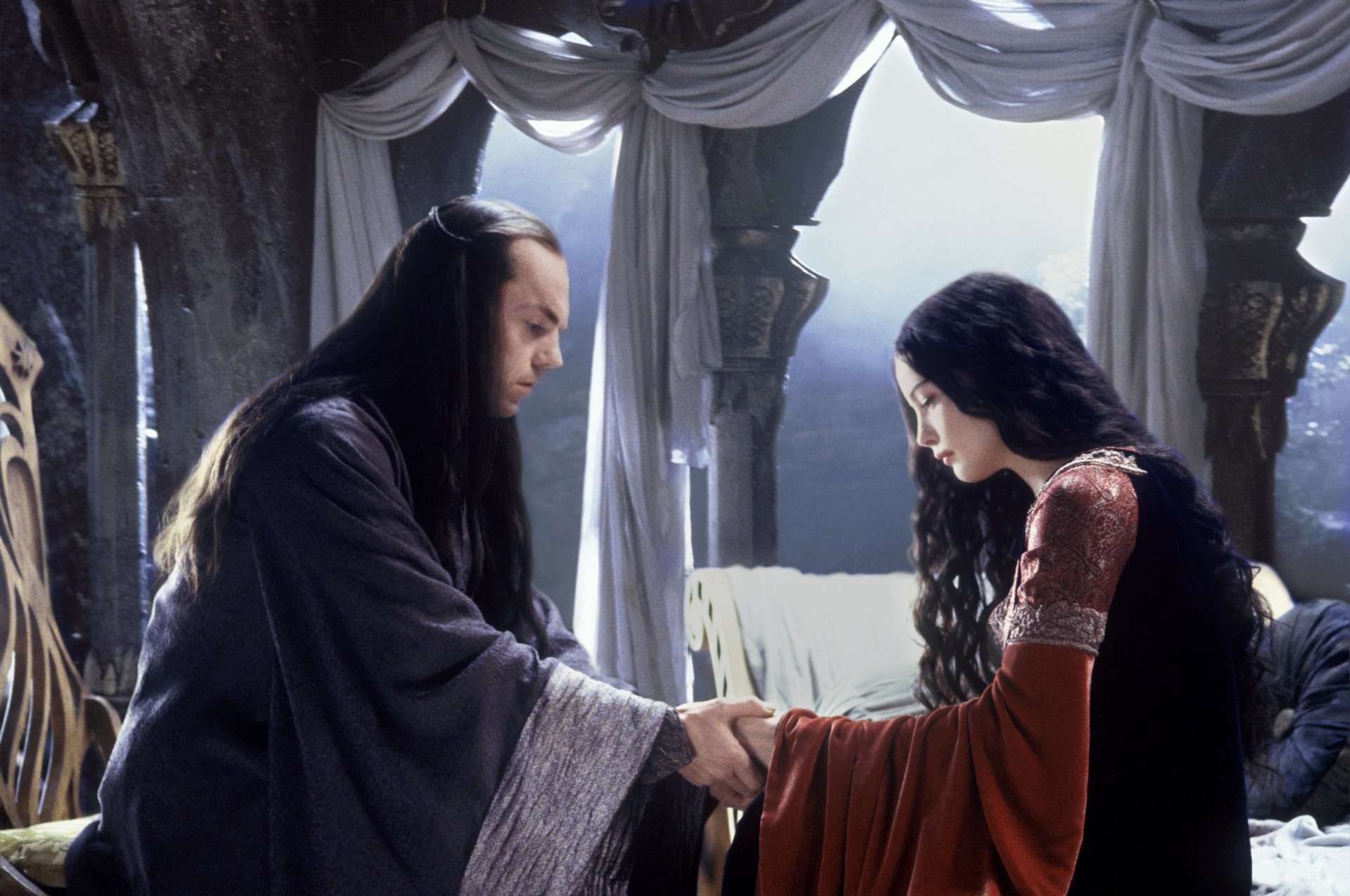 HD desktop wallpaper featuring a scene from The Lord of the Rings: The Return of the King, showing a solemn moment between two characters in a dimly lit room.
