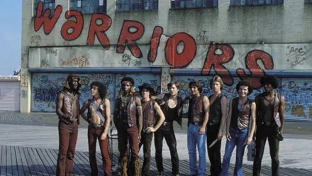 Image from the movie The Warriors, featuring a group of gang members in front of a graffiti-covered wall, showcasing iconic scenes from the film. HD PC desktop wallpaper and background.