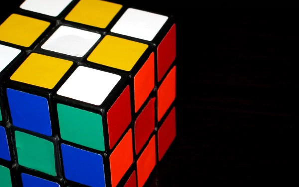 HD desktop wallpaper featuring a vibrant Rubik's Cube with colorful squares, set against a dark background.