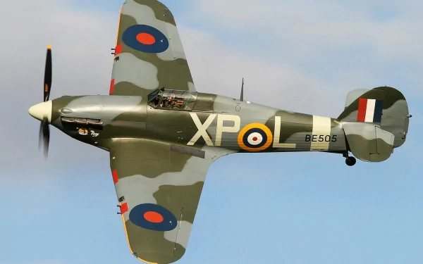 HD desktop wallpaper featuring a military Hawker Hurricane aircraft in flight with camouflage paint and RAF roundels against a clear sky background.