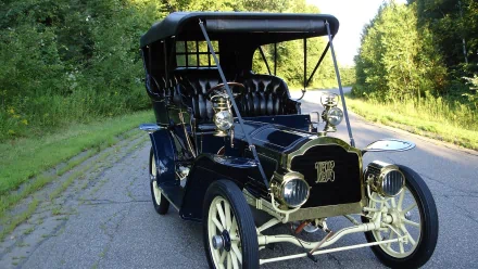 A vintage Packard vehicle parked on a sunlit rural road, captured in high definition as a PC desktop wallpaper and background.