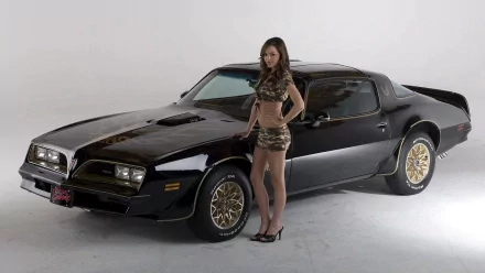 A stylish woman poses confidently beside a sleek black car, showcasing a striking combination of elegance and automotive allure. This HD desktop wallpaper captures the essence of girls and cars.