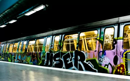 Artistic graffiti covers a subway train, creating a vibrant and edgy HD PC desktop wallpaper with bold colors and urban street style.