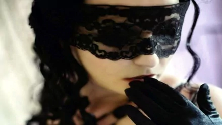 A dark, gothic image featuring a figure with a lace mask and black gloves, exuding an air of mystery. This HD wallpaper captures a striking blend of elegance and intrigue.