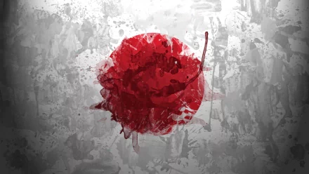 Abstract representation of the Japanese flag featuring a bold red circle, set against a textured gray background. This HD wallpaper adds a creative touch to any desktop.