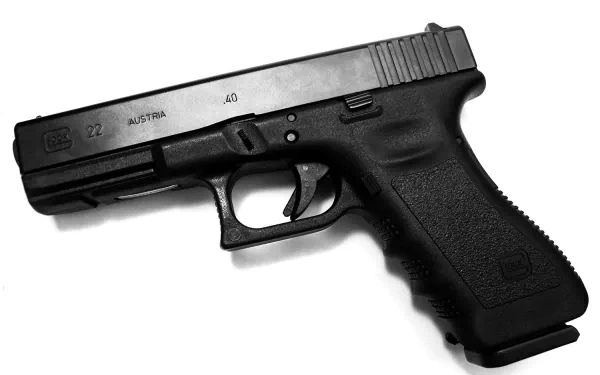 HD desktop wallpaper featuring a detailed image of a Glock pistol, showcasing its sleek, black design and sturdy structure.