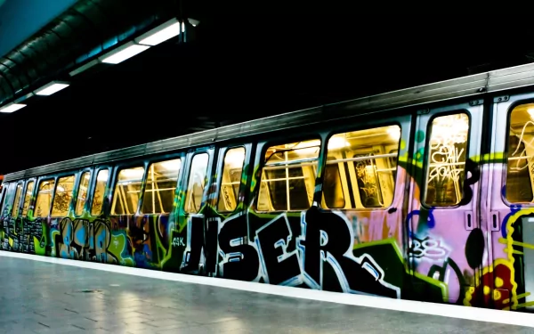 Artistic graffiti covers a subway train, creating a vibrant and edgy HD PC desktop wallpaper with bold colors and urban street style.