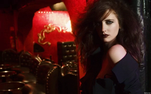A striking HD wallpaper features celebrity Eva Green, showcasing her dramatic look against a vibrant red background with elegant furnishings.
