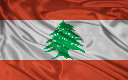 HD desktop wallpaper featuring the flag of Lebanon with its iconic green cedar tree on a wavy red and white background.