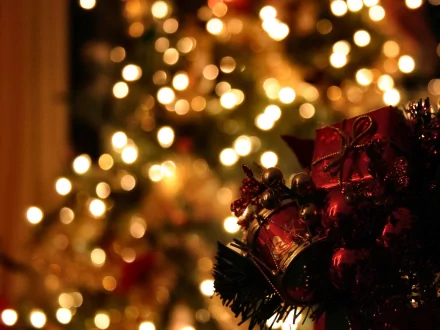 A beautiful HD wallpaper featuring Christmas ornaments and softly glowing holiday lights, creating a warm and festive atmosphere for the season.