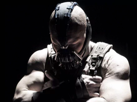 HD PC wallpaper from the movie The Dark Knight Rises: Bane in his mask and harness, muscular figure hunched forward in stark, high-contrast shadow.