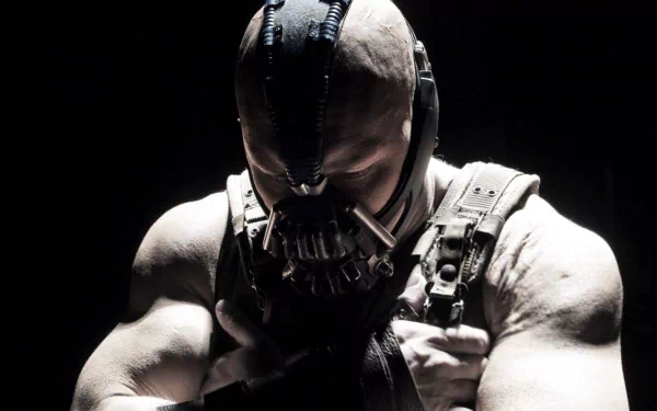 HD PC wallpaper from the movie The Dark Knight Rises: Bane in his mask and harness, muscular figure hunched forward in stark, high-contrast shadow.