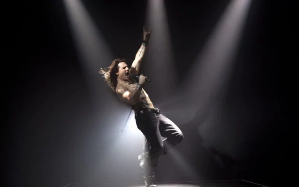 HD PC desktop wallpaper from the movie Rock of Ages: shirtless rock vocalist leans back with a microphone, arm raised amid dramatic stage spotlights and smoky concert lighting.