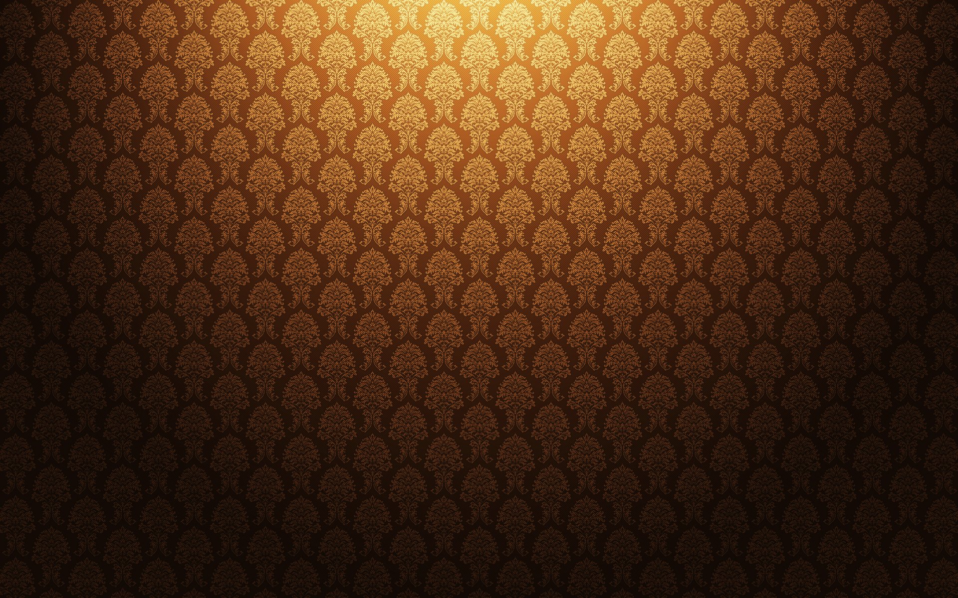 HD PC desktop wallpaper: warm golden-brown abstract repeating damask pattern with subtle vignette lighting.