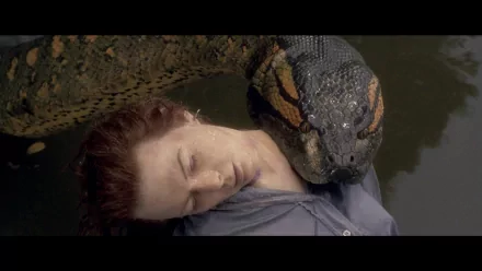 A dramatic scene from the movie Anaconda, featuring a woman submerged in water with a massive snake coiled around her, presented as a high-definition PC desktop wallpaper.