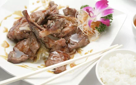 HD PC desktop wallpaper featuring a close-up of Chinese food with glazed meat, white rice, and garnishes including a purple flower and chopsticks.
