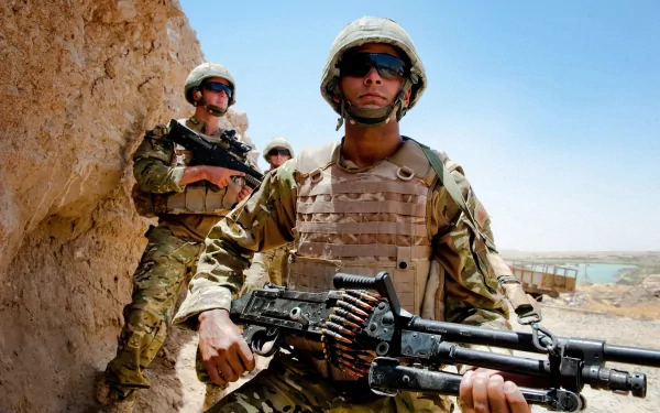 U.S. Army Infantry soldiers in combat gear holding weapons in a desert setting, representing military service and warfare.