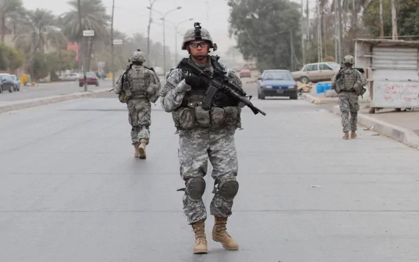 U.S. Army Infantry soldiers armed and patrolling a street in a war zone, captured in high definition for a military-themed desktop wallpaper.