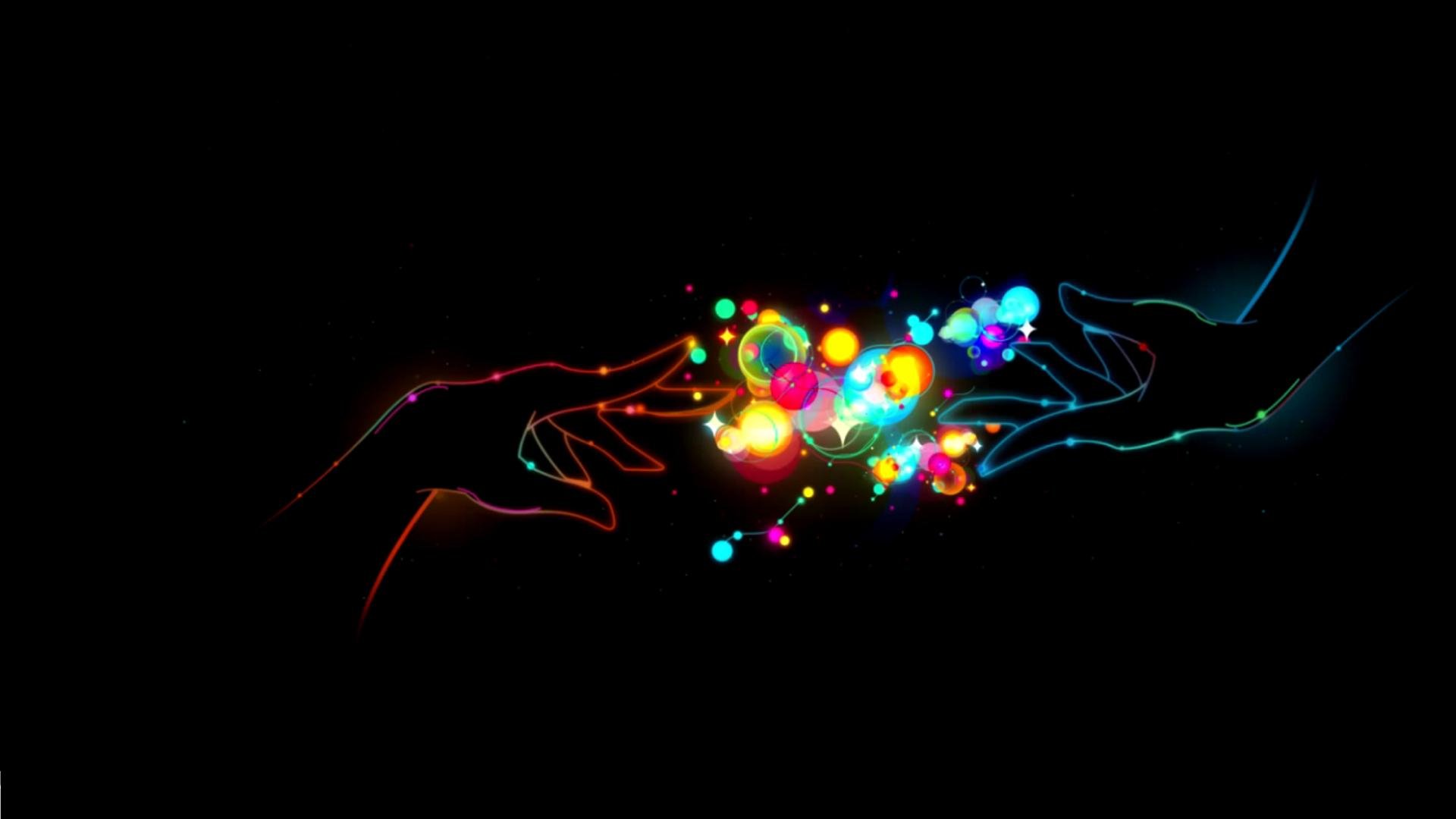 A vibrant HD desktop wallpaper capturing two colorful hands reaching toward each other, surrounded by glowing lights and artistic representations of love.