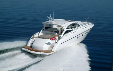 White luxury yacht (vehicle) speeding across deep-blue sea, wake trailing behind — HD PC desktop wallpaper/background of a sleek motor yacht on open water.
