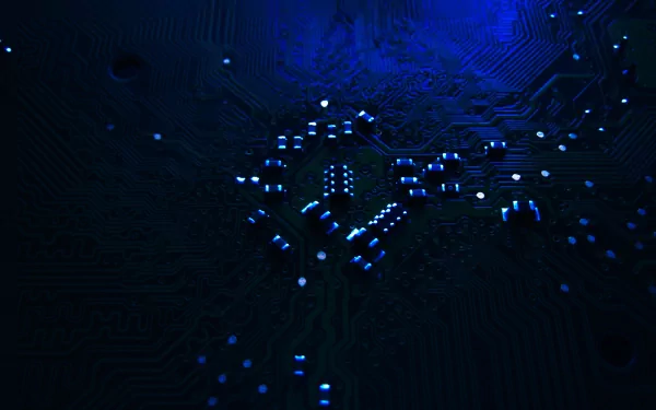 A high-definition desktop wallpaper featuring intricate circuitry illuminated by blue light, highlighting a technological and hardware theme.