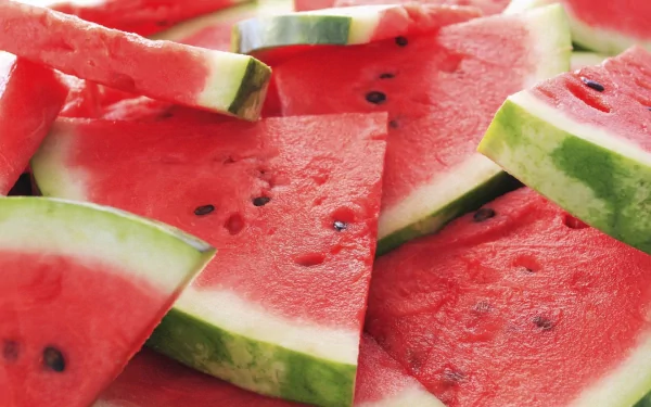 HD PC desktop wallpaper featuring a close-up of fresh watermelon slices with vibrant red flesh and green rind.