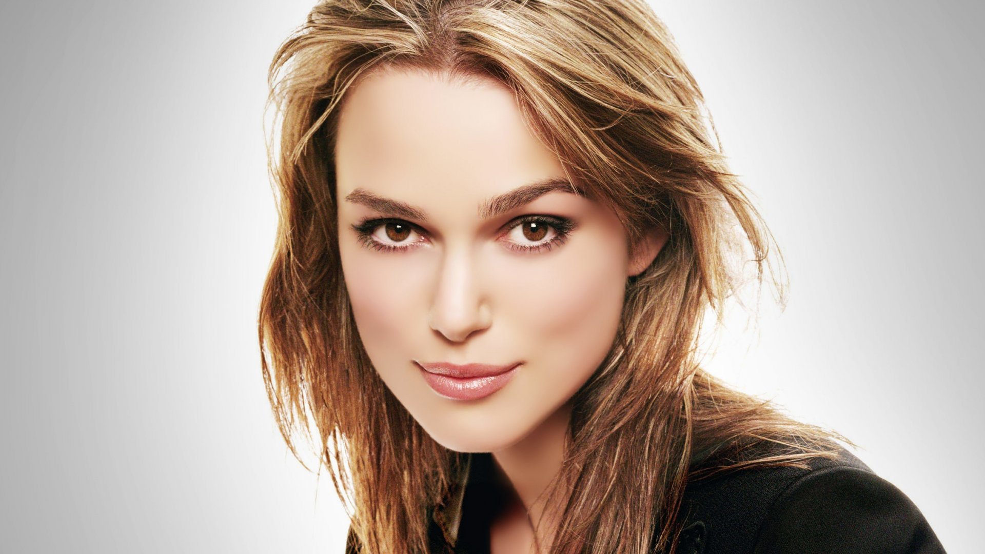Close-up portrait of Keira Knightley with soft lighting, showcasing her natural beauty. An HD wallpaper featuring this celebrated actress as a stunning desktop background.