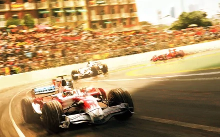 HD PC desktop wallpaper featuring high-speed F1 cars racing on a sunlit track with blurred spectators in the background, capturing the thrill of motorsports.