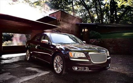 HD PC desktop wallpaper showing a Chrysler 300 luxury vehicle — dark sedan parked by a modern house, wet driveway reflecting dramatic morning light.