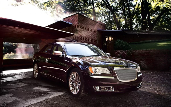 HD PC desktop wallpaper showing a Chrysler 300 luxury vehicle — dark sedan parked by a modern house, wet driveway reflecting dramatic morning light.