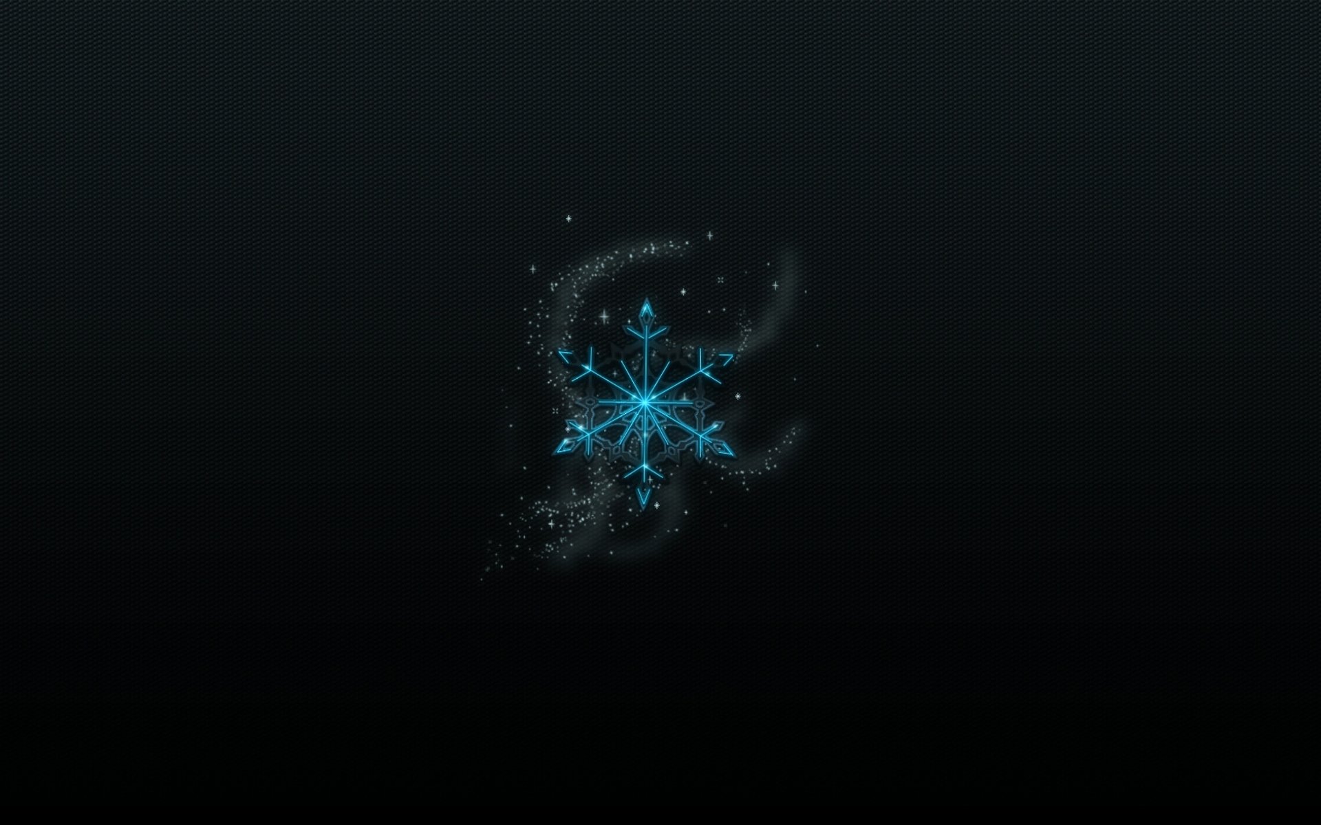 Abstract artistic HD desktop wallpaper featuring a glowing blue snowflake with sparkling particle effects on a dark background.