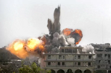 HD desktop wallpaper showcasing a dramatic military explosion, with intense flames and thick smoke engulfing a building in the foreground.