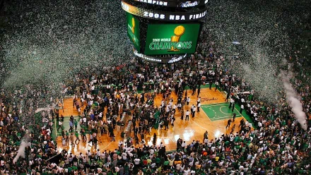 HD PC desktop wallpaper capturing the Boston Celtics' championship celebration on the basketball court with fans and confetti filling the arena.