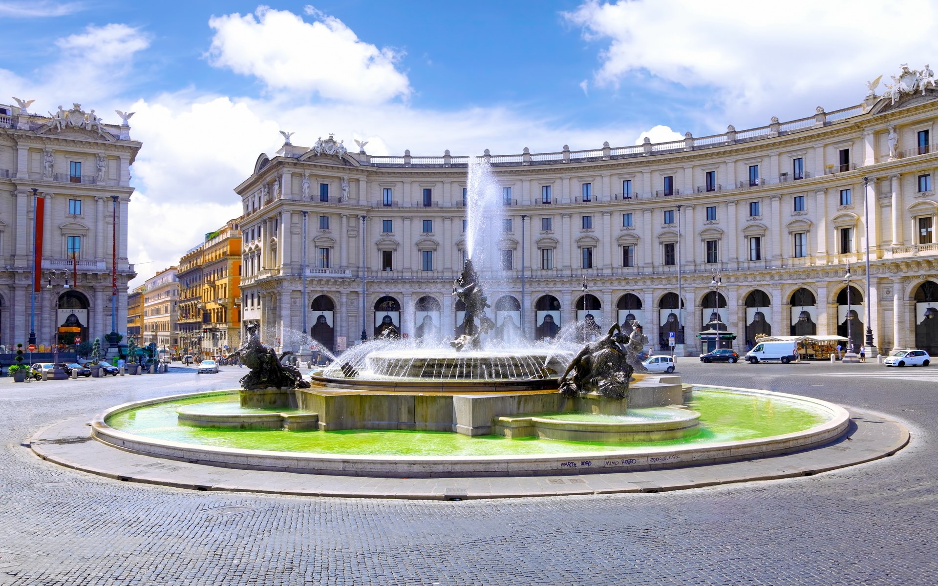 A stunning view of a fountain in Rome, featuring a majestic statue, surrounded by historic buildings and a lively road, captured beautifully for an inspiring HD desktop wallpaper.