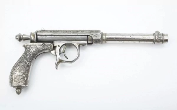 A detailed, silver antique pistol with intricate engravings, showcased against a clean background. This HD wallpaper captures the craftsmanship of man-made weaponry.