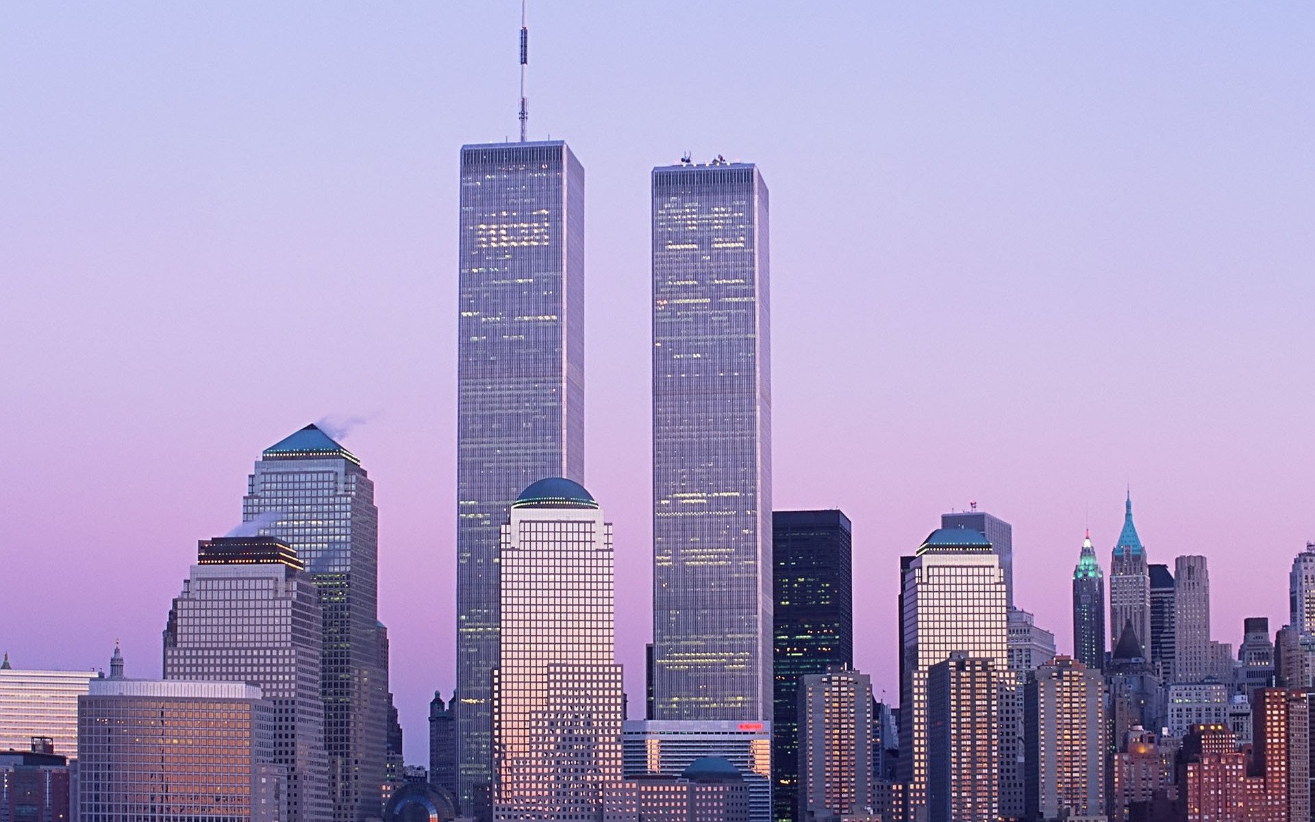 HD desktop wallpaper featuring the iconic Manhattan skyline of New York with the Twin Towers standing tall against a soft purple sky.