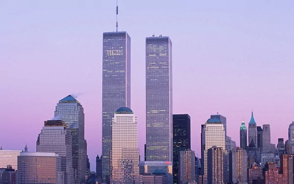 HD desktop wallpaper featuring the iconic Manhattan skyline of New York with the Twin Towers standing tall against a soft purple sky.